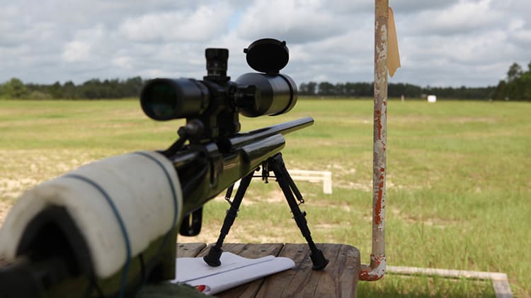 Bolt-action rifle with mounted scope on a bench rest — optics and accessories at Hammond Tactical, Hammond, IN
